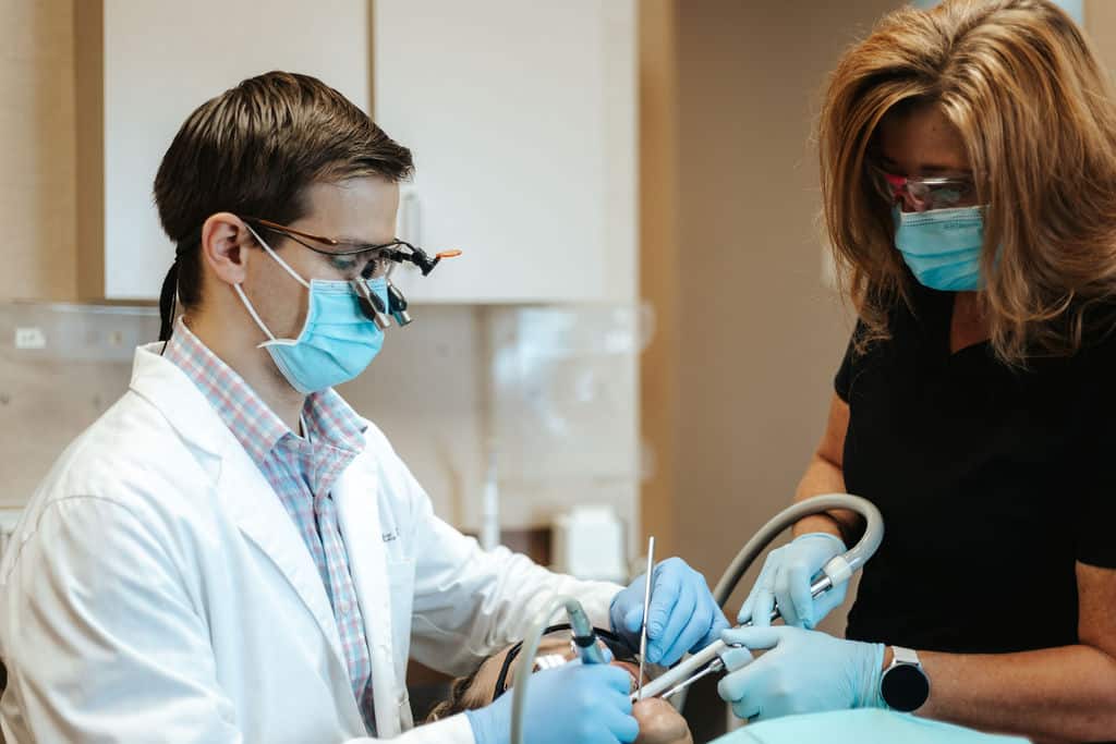 dentist and assistant working on patient