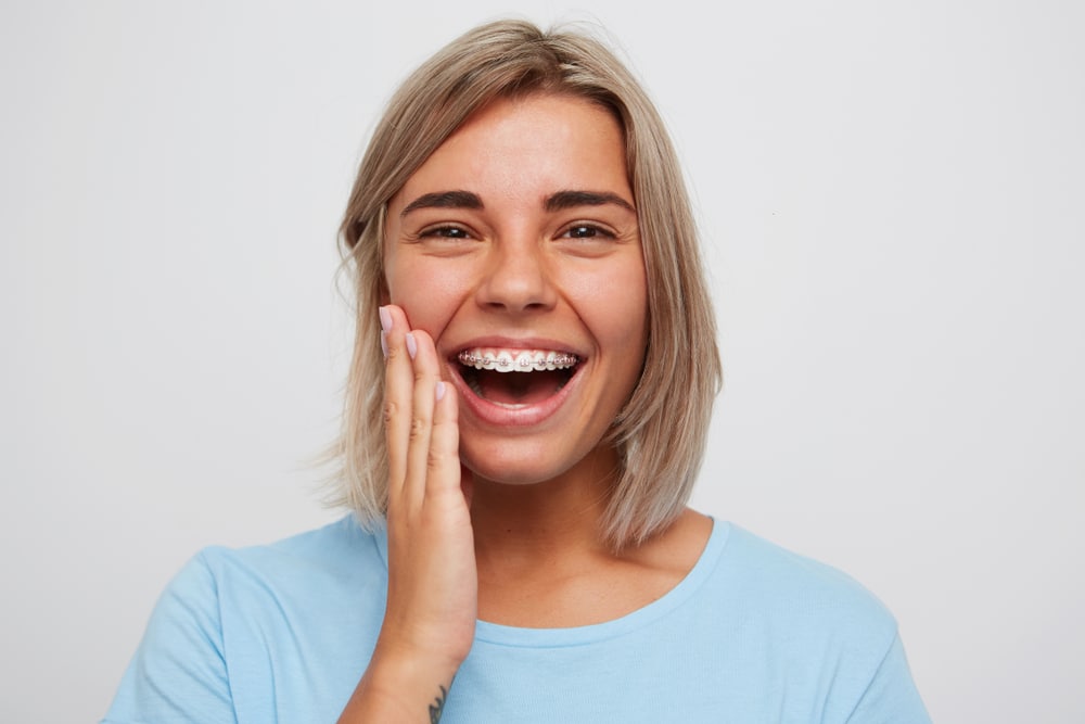 girl surprised with invisalign on