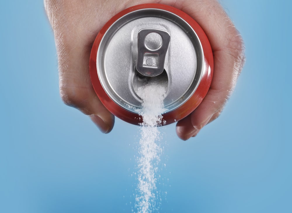sugar pouring out of a soda can